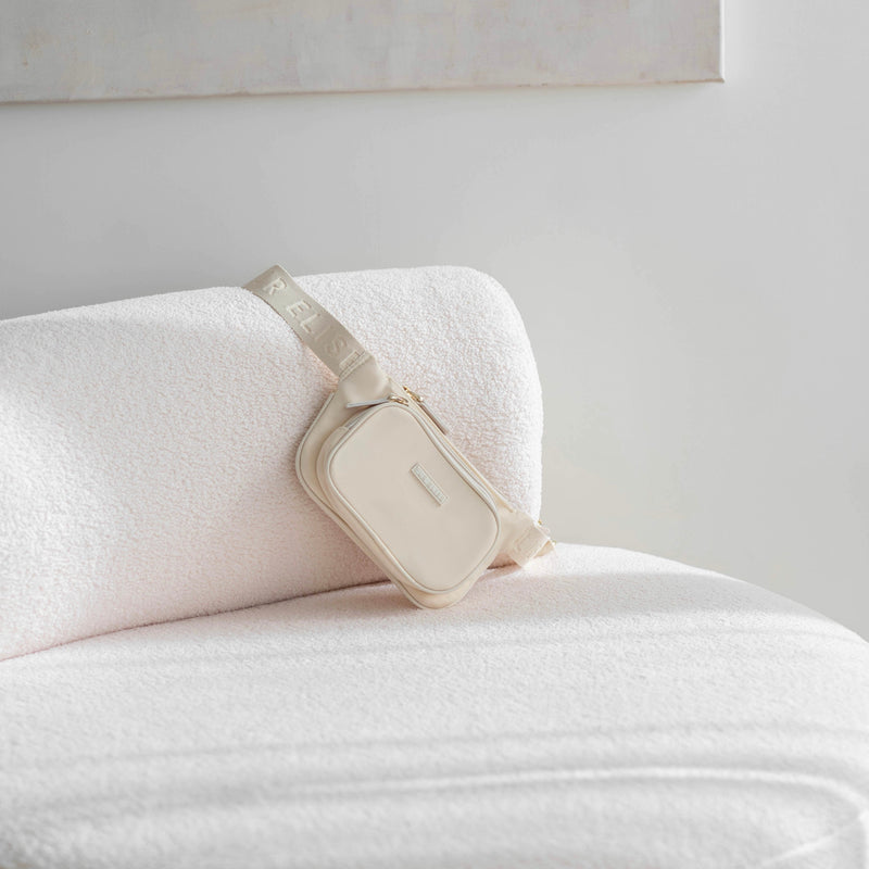 Elise belt bag on a white boucle couch
