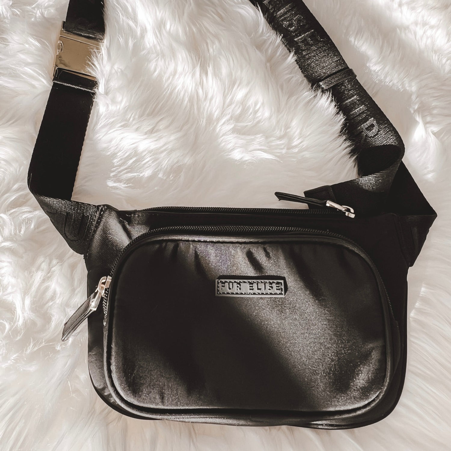 Black belt bag on a rug