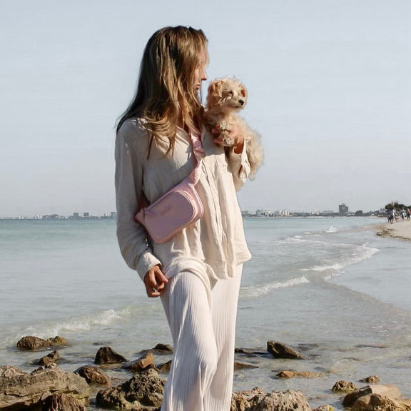 Model wearing pink dog walking bag